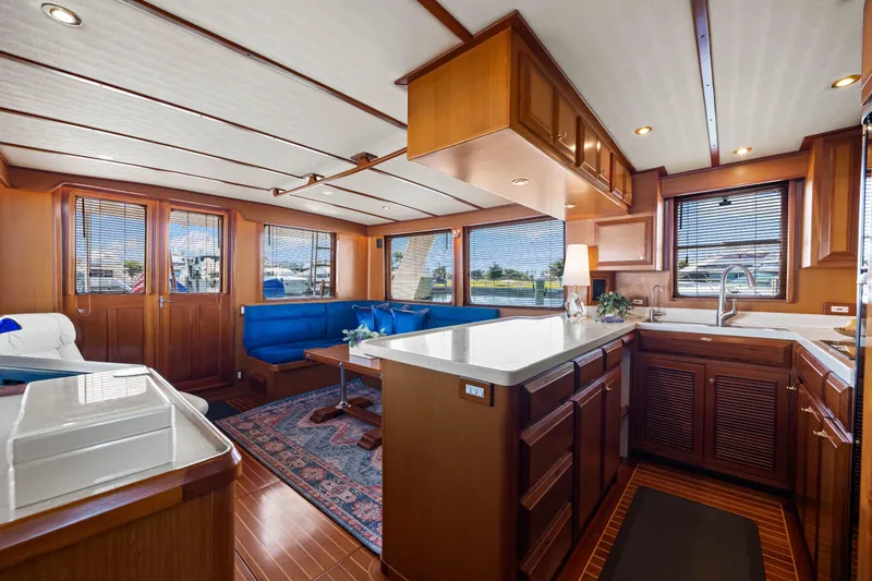 Sugar Yacht Photos Pics Luxurious interior of 2008 DeFever 52 Euro yacht with elegant wood finishes and modern amenities.