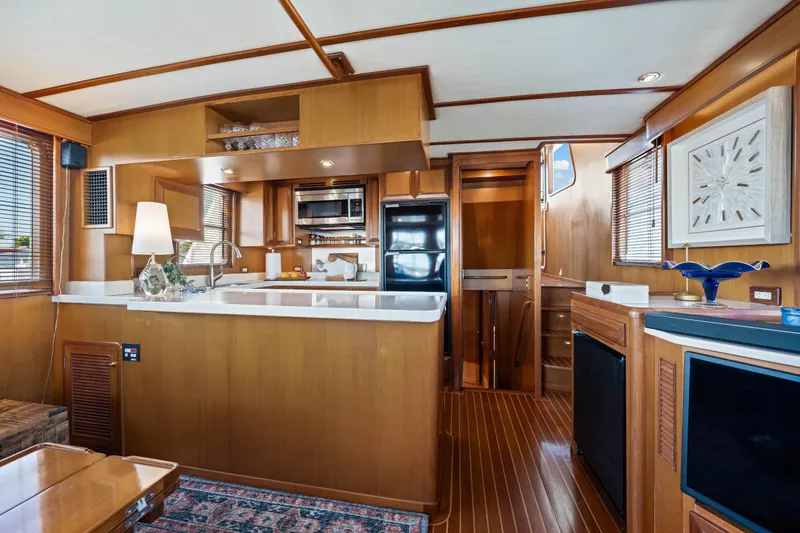 Sugar Yacht Photos Pics Luxurious 2008 DeFever 52 Euro yacht interior with modern kitchen and elegant wood finishes.