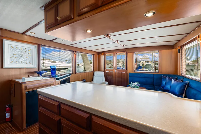 Sugar Yacht Photos Pics Luxurious interior of 2008 DeFever 52 Euro yacht with elegant wood finishes and plush seating.