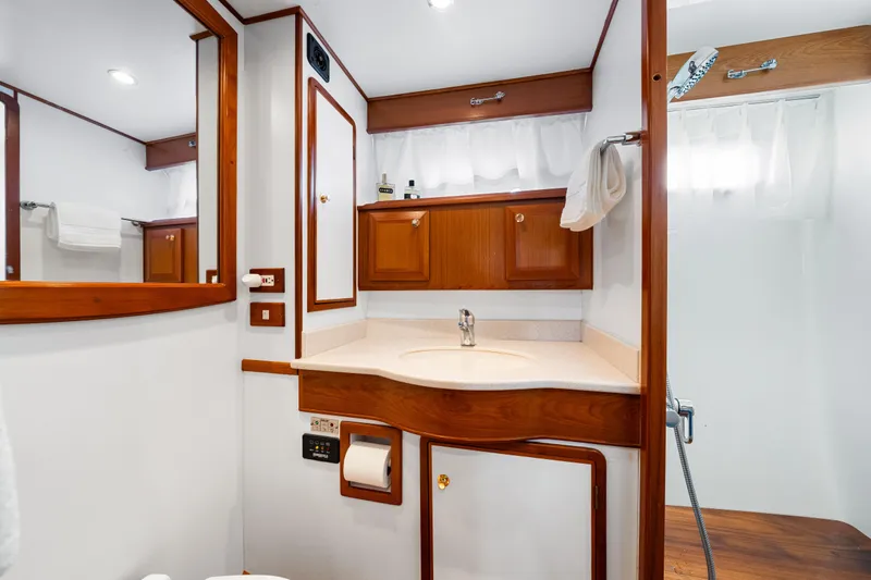 Sugar Yacht Photos Pics Luxurious 2008 DeFever 52 Euro yacht bathroom with wood accents and modern fixtures.
