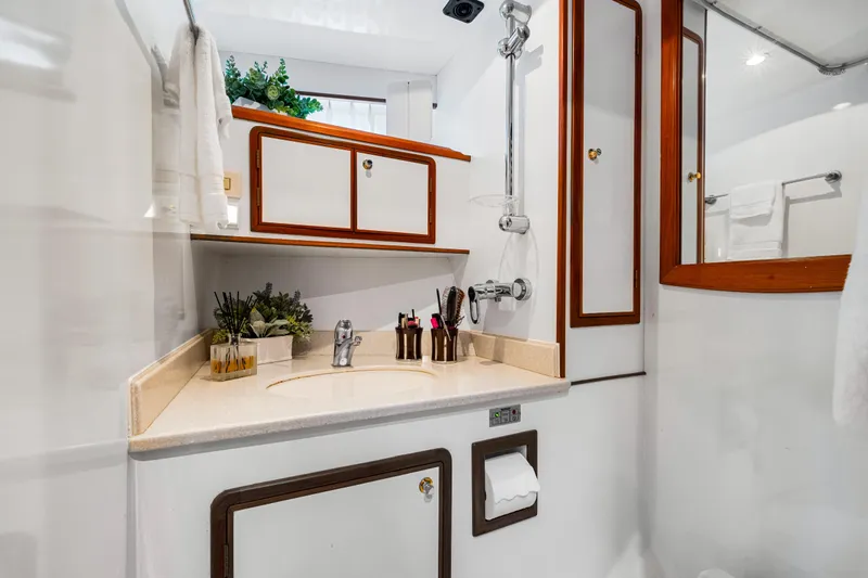 Sugar Yacht Photos Pics Luxurious 2008 DeFever 52 Euro yacht bathroom with elegant wood accents and modern fixtures.