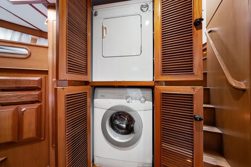 Sugar Yacht Photos Pics Laundry area with stacked washer and dryer in 2008 DeFever 52 Euro yacht.