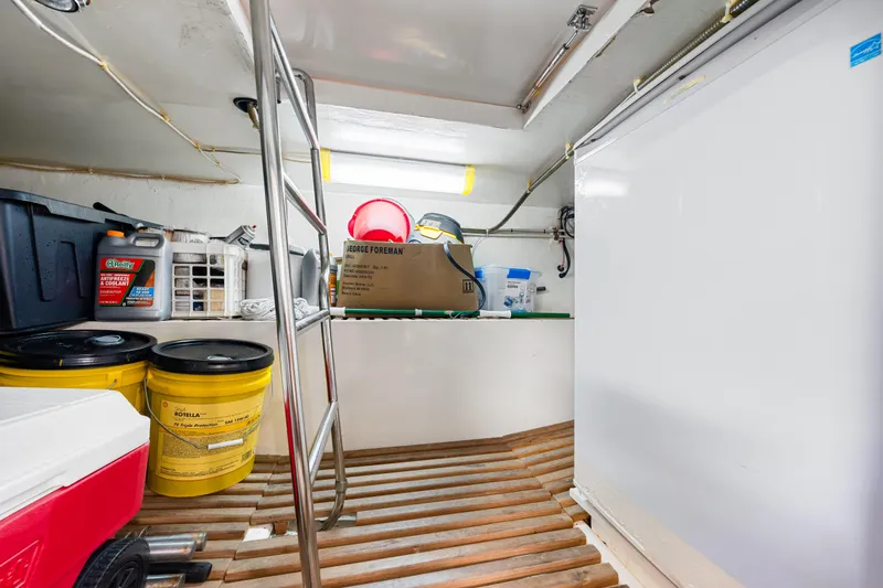 Sugar Yacht Photos Pics Storage area in a 2008 DeFever 52 Euro yacht with various supplies and equipment.