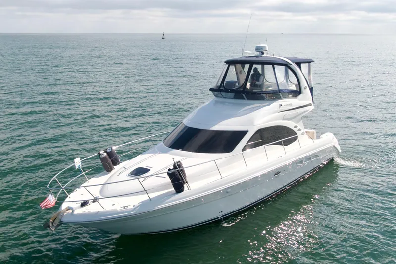  Yacht Photos Pics 2009 Sea Ray 44 Sedan Bridge yacht cruising on open water.