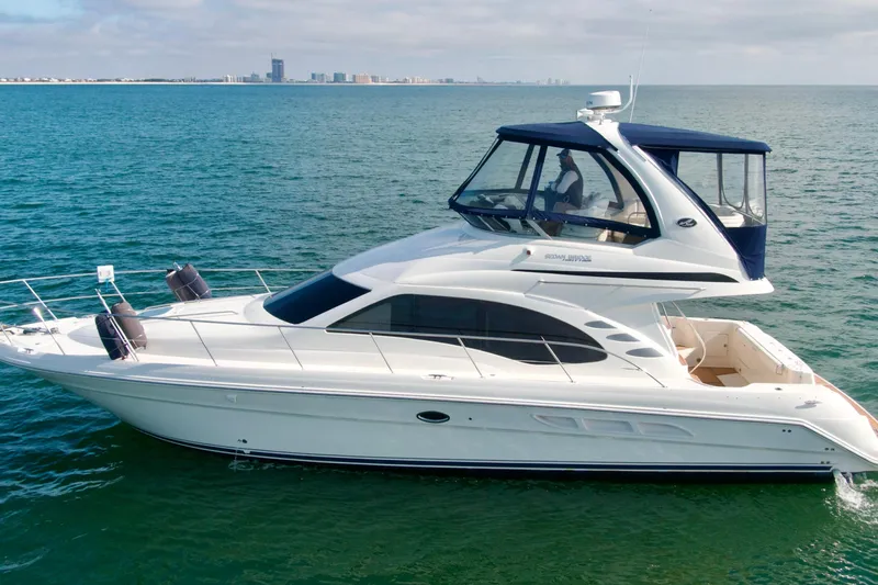  Yacht Photos Pics 2009 Sea Ray 44 Sedan Bridge yacht cruising on open water.