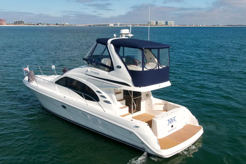  Yacht Photos Pics 2009 Sea Ray 44 Sedan Bridge yacht cruising on open water.