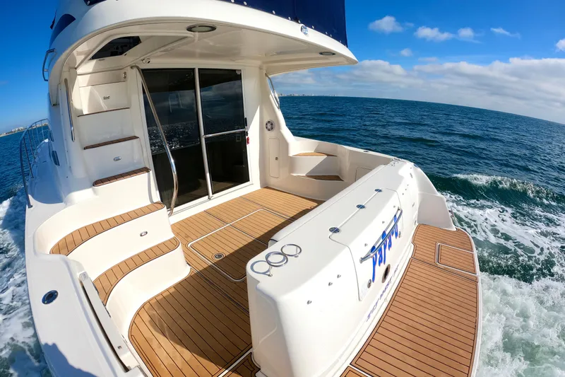  Yacht Photos Pics 2009 Sea Ray 44 Sedan Bridge yacht cruising on open water, featuring spacious deck and seating.