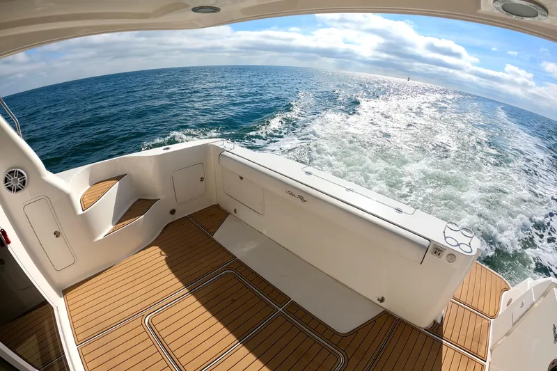  Yacht Photos Pics 2009 Sea Ray 44 Sedan Bridge yacht cruising on open water, featuring teak deck.