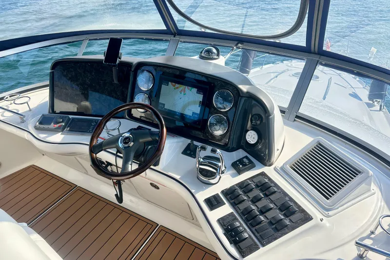  Yacht Photos Pics 2009 Sea Ray 44 Sedan Bridge helm with navigation controls and wooden steering wheel.