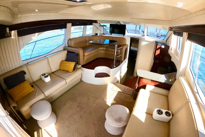  Yacht Photos Pics Luxurious interior of 2009 Sea Ray 44 Sedan Bridge yacht with plush seating and panoramic windows.