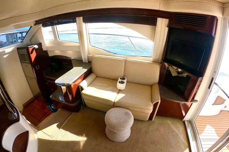  Yacht Photos Pics Luxurious interior of 2009 Sea Ray 44 Sedan Bridge yacht with sofa and ocean view.