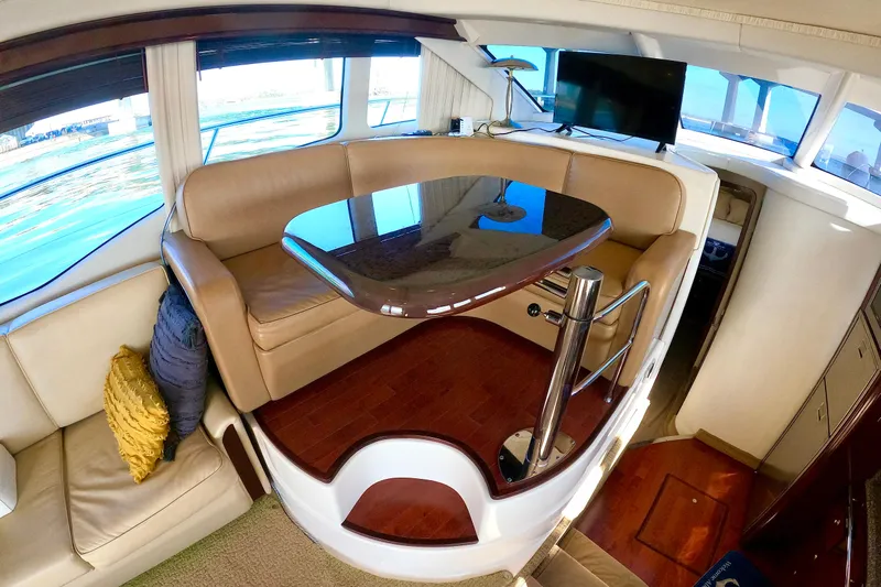  Yacht Photos Pics Luxurious interior of 2009 Sea Ray 44 Sedan Bridge yacht with elegant seating and table.
