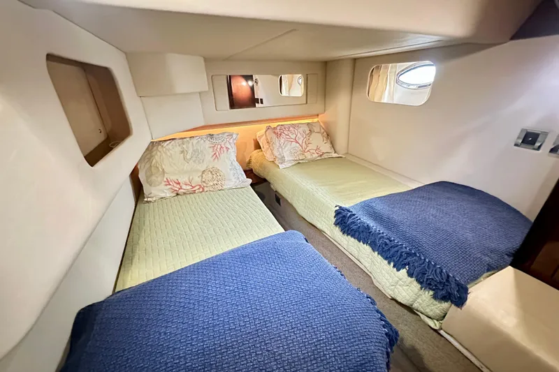  Yacht Photos Pics 2009 Sea Ray 44 Sedan Bridge cabin with twin beds, cozy decor, and porthole windows.