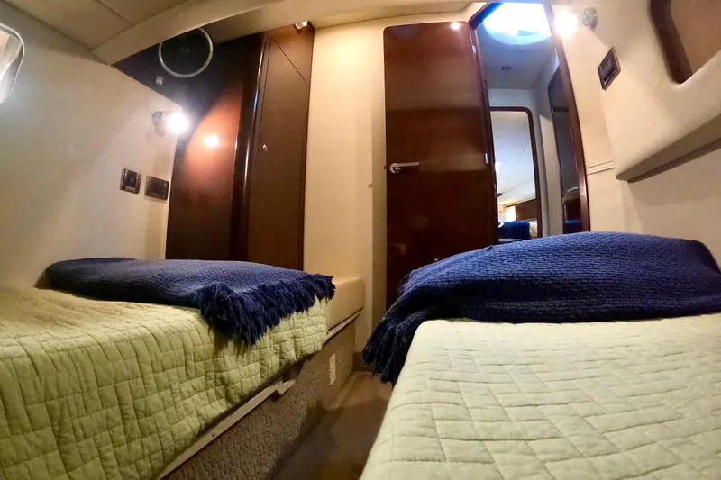  Yacht Photos Pics 2009 Sea Ray 44 Sedan Bridge cabin interior with twin beds and cozy lighting.