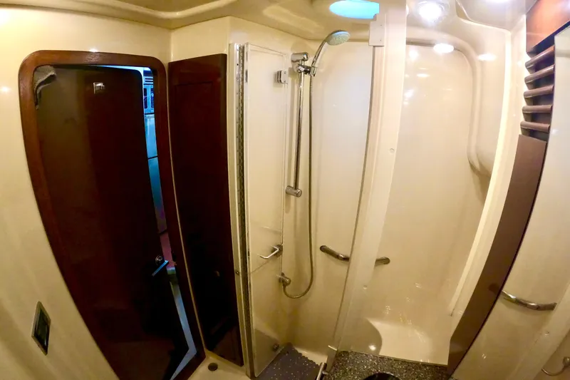  Yacht Photos Pics 2009 Sea Ray 44 Sedan Bridge bathroom with shower, modern fixtures, and wooden accents.