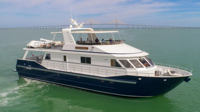 Island Soul Yacht Photos Pics Custom 2009 Flybridge Motoryacht cruising on calm waters with bridge in background.