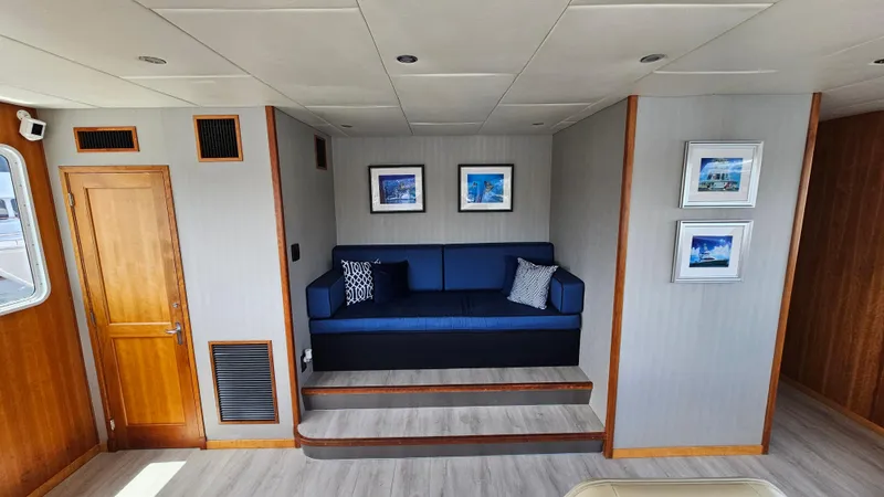 Island Soul Yacht Photos Pics Luxurious 2009 Custom Flybridge Motoryacht interior with blue sofa and framed artwork.