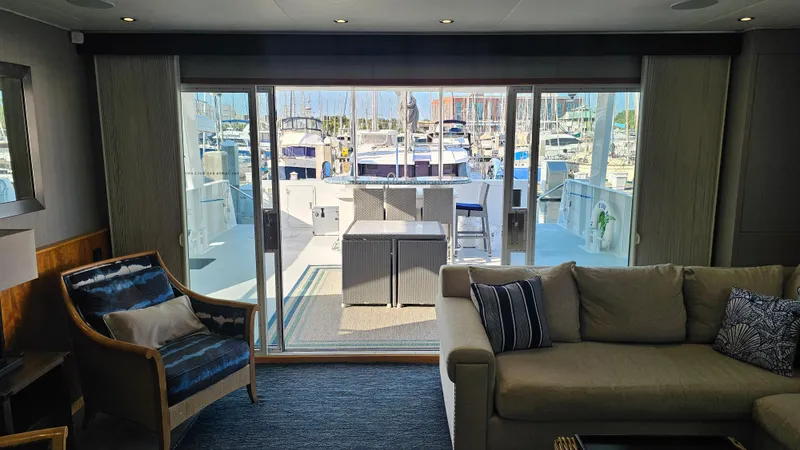 Island Soul Yacht Photos Pics Luxurious 2009 Custom Flybridge Motoryacht interior with marina view through sliding glass doors.