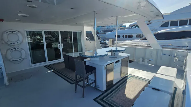 Island Soul Yacht Photos Pics Luxurious 2009 Custom Flybridge Motoryacht deck with seating, bar, and marina view.