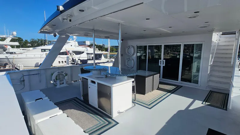 Island Soul Yacht Photos Pics Luxurious 2009 Custom Flybridge Motoryacht deck with seating, bar, and marina view.