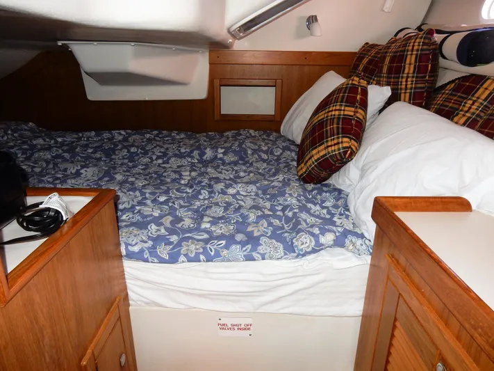 Milky Way Yacht Photos Pics Cozy cabin interior of a 2004 Catalina 350 sailboat with floral bedding and plaid pillows.