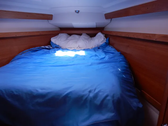 Milky Way Yacht Photos Pics Cozy cabin bed with blue bedding in a 2004 Catalina 350 sailboat.