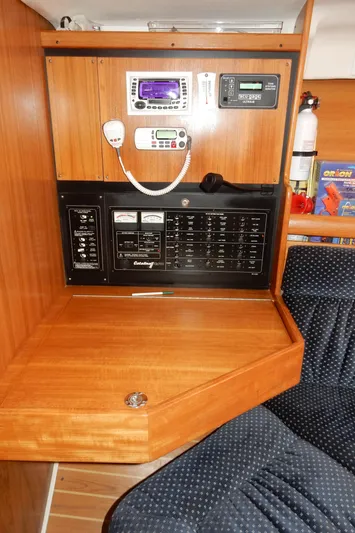 Milky Way Yacht Photos Pics Navigation station of a 2004 Catalina 350 sailboat with control panels and radio equipment.