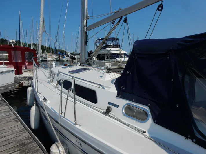 Milky Way Yacht Photos Pics 2004 Catalina 350 sailboat docked at marina, featuring sleek design and blue canopy.