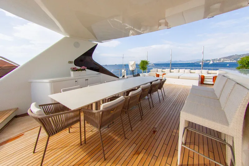  Yacht Photos Pics Luxurious yacht deck with dining area, wooden flooring, and ocean view, Factoria Naval de Marin 2013.