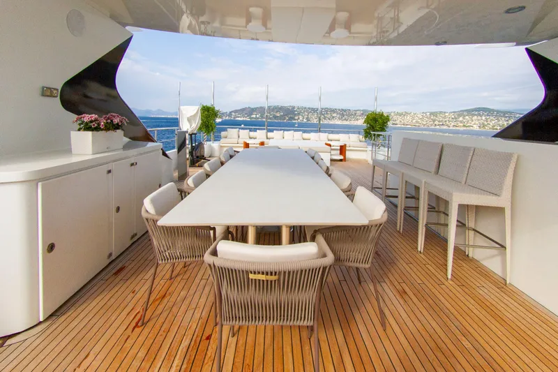 Yacht Photos Pics Luxurious yacht deck with dining area, wicker chairs, and ocean view, Factoria Naval de Marin 40, 2013.