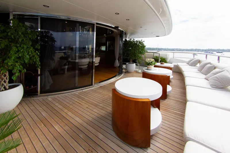  Yacht Photos Pics Luxurious yacht deck with wooden flooring, white seating, and round tables, Factoria Naval de Marin 40, 2013.