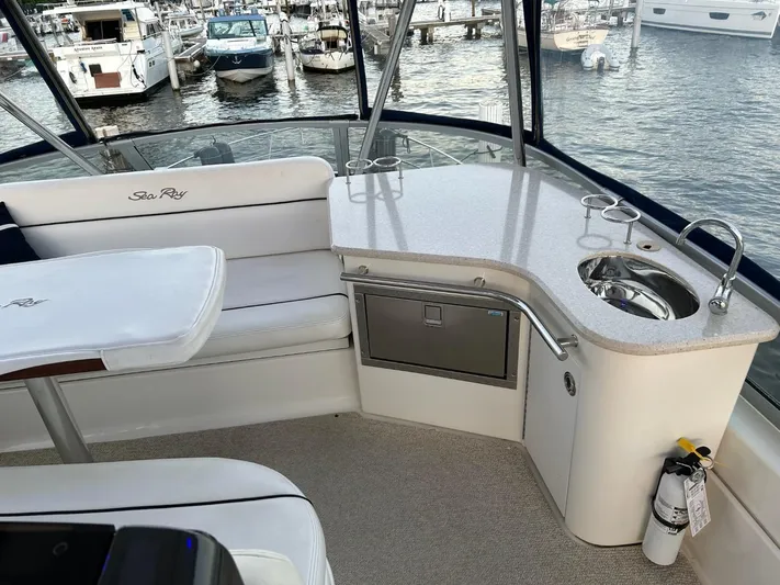 Someday Came Yacht Photos Pics 2008 Sea Ray 47 Sedan Bridge yacht interior with seating, sink, and marina view.