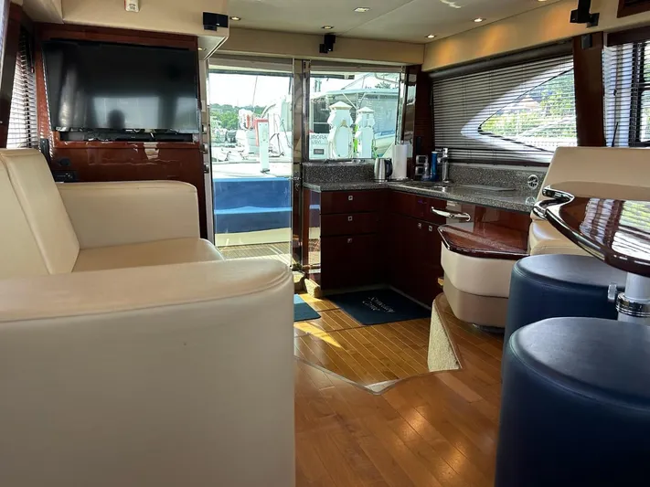Someday Came Yacht Photos Pics Interior of 2008 Sea Ray 47 Sedan Bridge yacht with modern furnishings and wood flooring.
