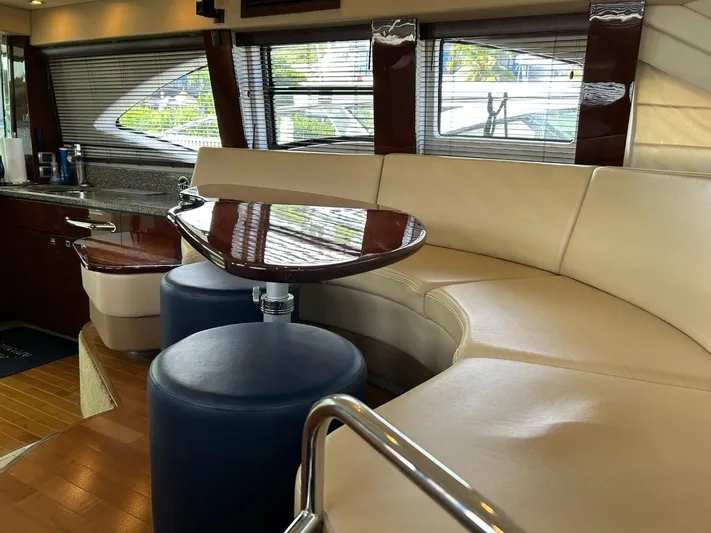 Someday Came Yacht Photos Pics Luxurious interior of 2008 Sea Ray 47 Sedan Bridge yacht with leather seating and wooden table.