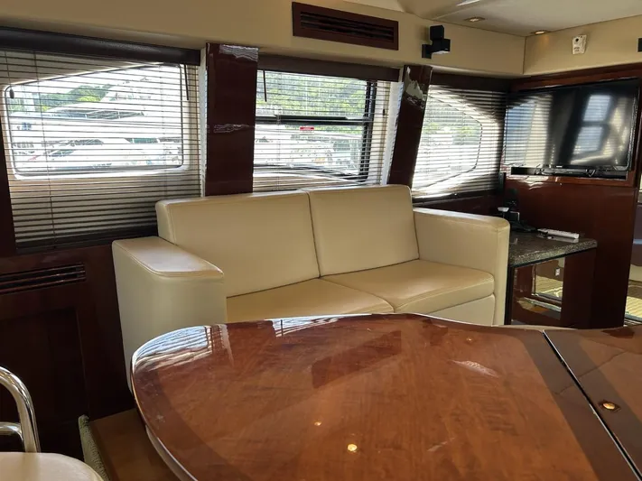 Someday Came Yacht Photos Pics Luxurious interior of 2008 Sea Ray 47 Sedan Bridge yacht with leather sofa and TV.