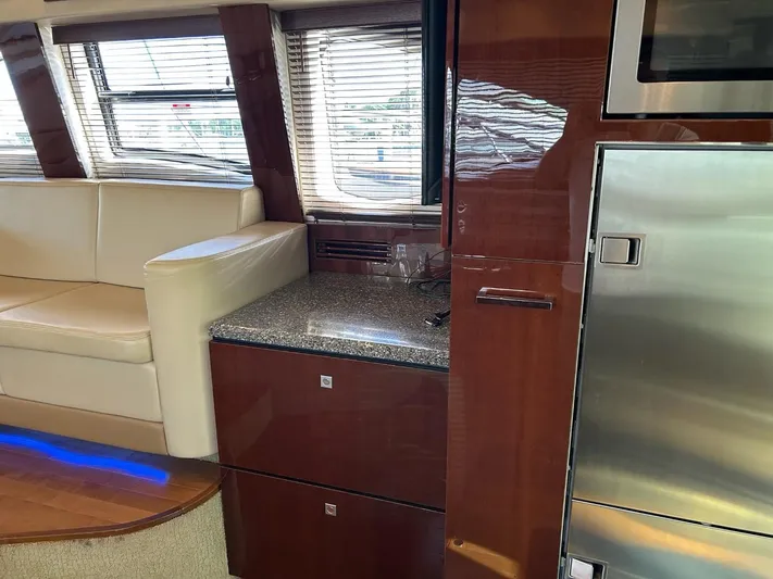 Someday Came Yacht Photos Pics Interior of 2008 Sea Ray 47 Sedan Bridge yacht with modern kitchen and seating area.