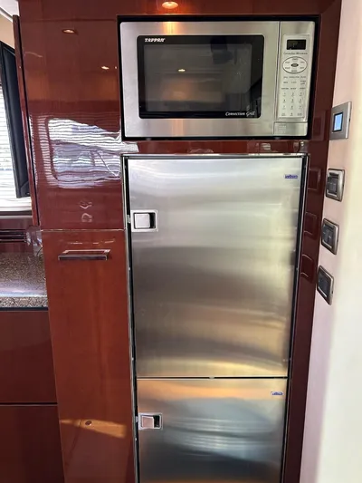 Someday Came Yacht Photos Pics Stainless steel microwave and fridge in 2008 Sea Ray 47 Sedan Bridge yacht kitchen.