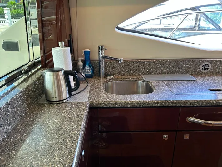 Someday Came Yacht Photos Pics Kitchen area of a 2008 Sea Ray 47 Sedan Bridge yacht with granite countertops.