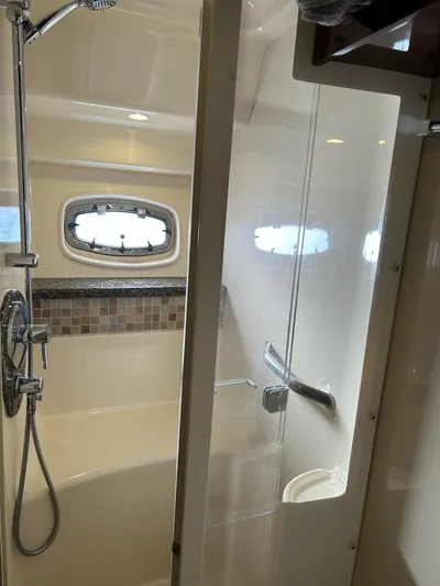 Someday Came Yacht Photos Pics 2008 Sea Ray 47 Sedan Bridge bathroom with shower, porthole, and modern fixtures.