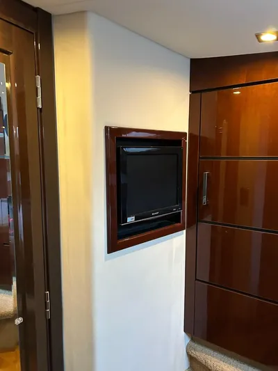 Someday Came Yacht Photos Pics 2008 Sea Ray 47 Sedan Bridge interior with mounted TV and wooden cabinetry.