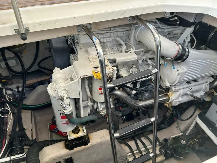 Someday Came Yacht Photos Pics Engine compartment of a 2008 Sea Ray 47 Sedan Bridge yacht, showcasing mechanical components.