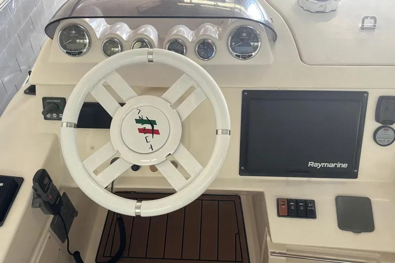 Sylvie Yacht Photos Pics Cockpit of 2009 Azimut 43 yacht with steering wheel and Raymarine navigation system.