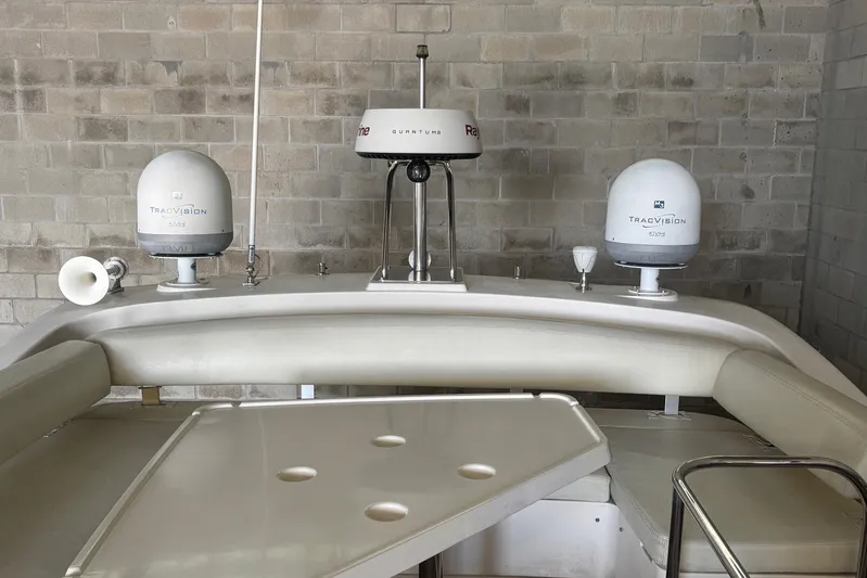 Sylvie Yacht Photos Pics 2009 Azimut 43 yacht interior with TracVision satellite systems and seating area.