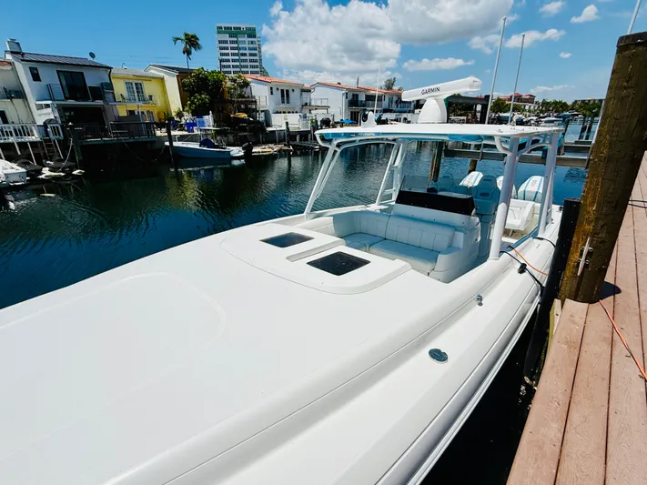  Yacht Photos Pics 2003 Intrepid 377 boat docked in a scenic waterfront setting under a clear blue sky.