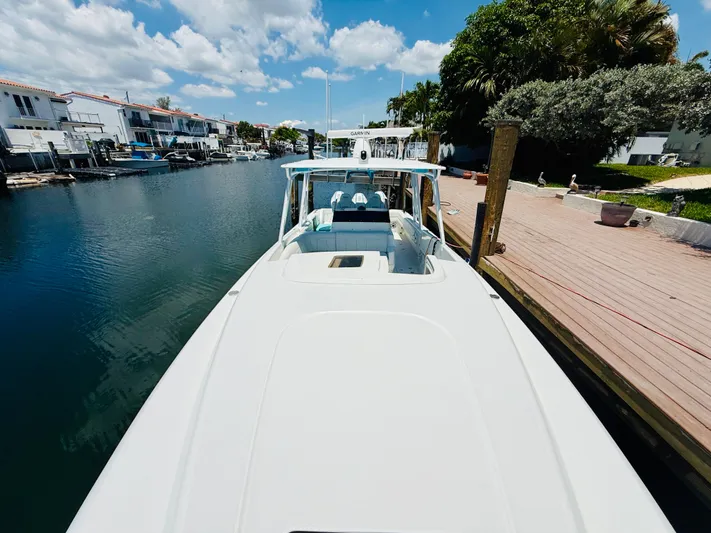  Yacht Photos Pics 2003 Intrepid 377 boat docked in a scenic canal with clear skies.