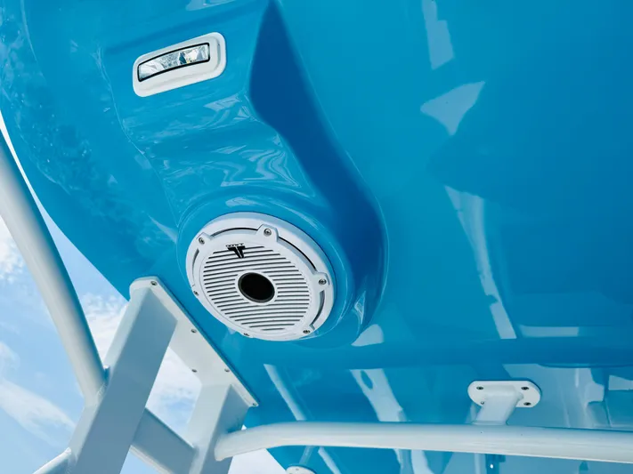  Yacht Photos Pics Close-up of a 2003 Intrepid 377 boat's blue hull with a speaker and light.