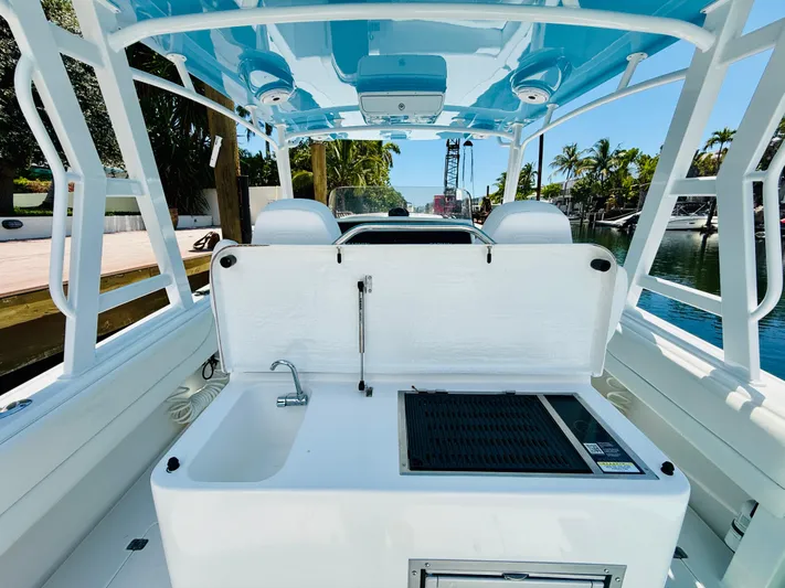  Yacht Photos Pics 2003 Intrepid 377 boat interior with sink and grill, docked by a canal.