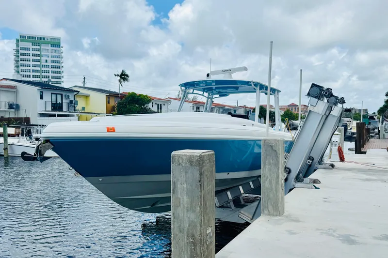  Yacht Photos Pics 2003 Intrepid 377 boat docked at marina with modern buildings in background.