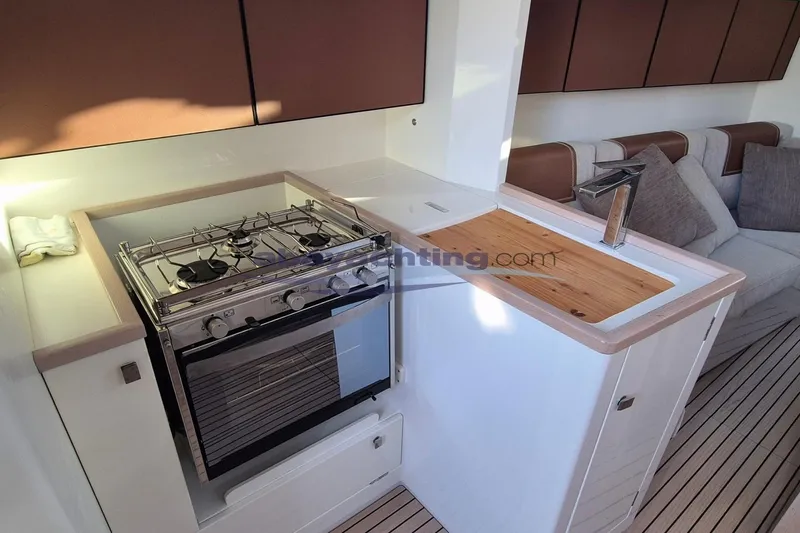  Yacht Photos Pics Italia Yachts 11.98 (2021) interior kitchen with stove and sink.