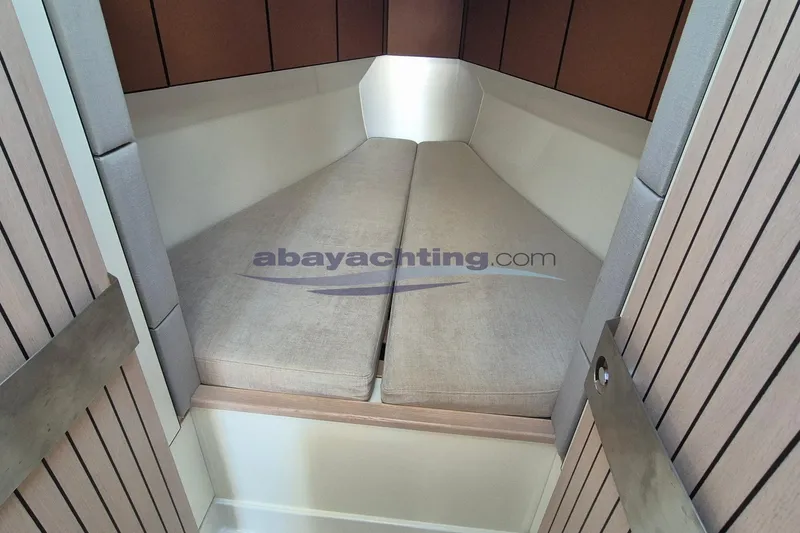  Yacht Photos Pics Italia Yachts 11.98 (2021) interior cabin with beige cushions and wooden paneling.